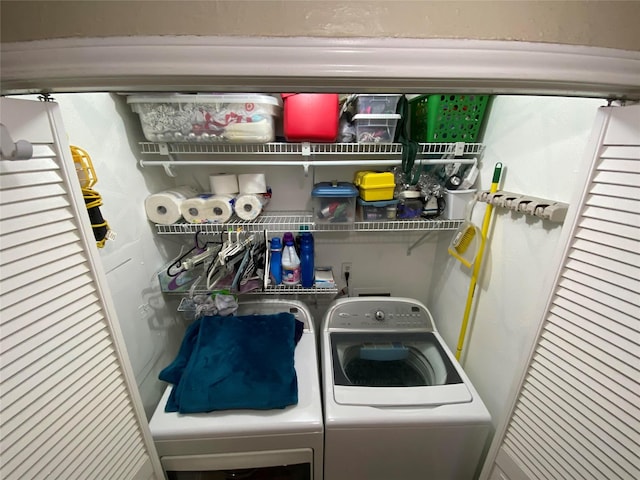 clothes washing area with washing machine and dryer