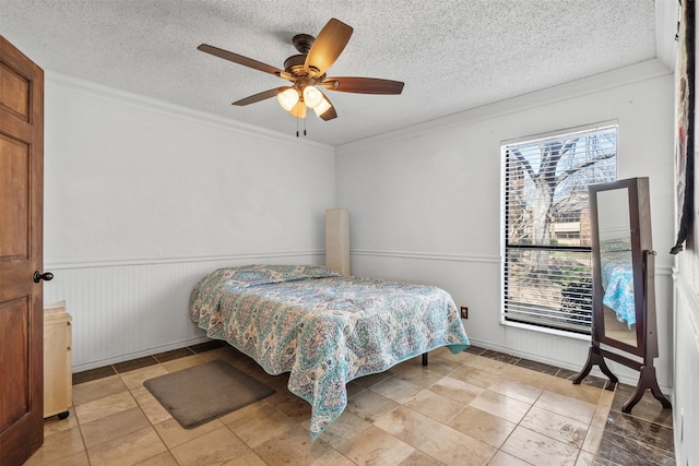 bedroom featuring crown molding, a textured ceiling, and ceiling fan