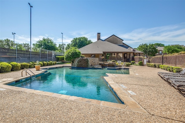 view of pool featuring a patio, a hot tub, and pool water feature