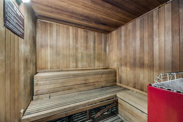 view of sauna featuring wooden walls and wooden ceiling