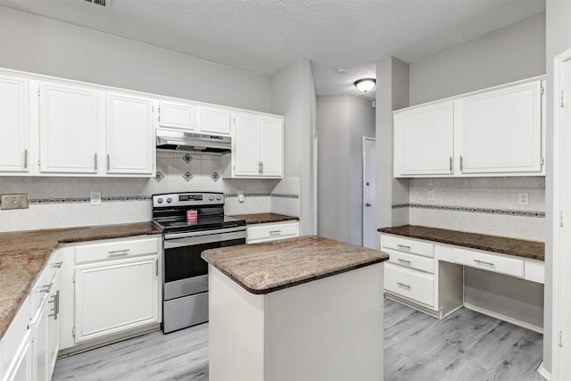 kitchen featuring a center island, a textured ceiling, electric range, decorative backsplash, and white cabinets