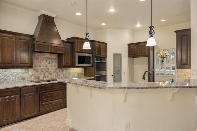 kitchen with premium range hood, a breakfast bar area, pendant lighting, stainless steel appliances, and light stone countertops