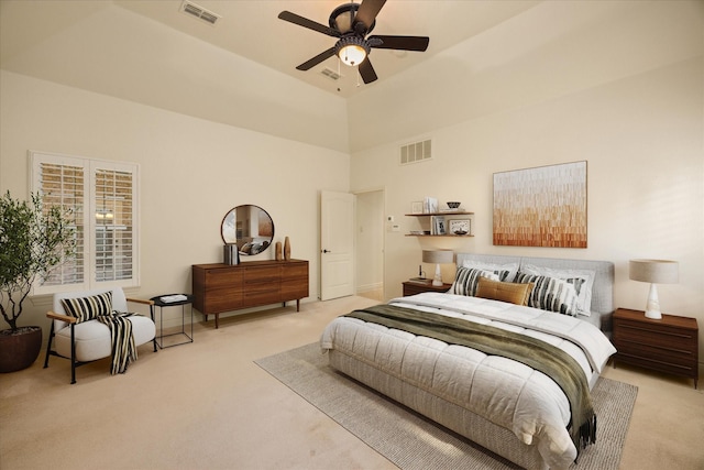 carpeted bedroom with a towering ceiling, visible vents, and a ceiling fan