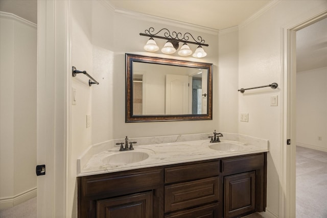 bathroom featuring ornamental molding, a sink, baseboards, and double vanity