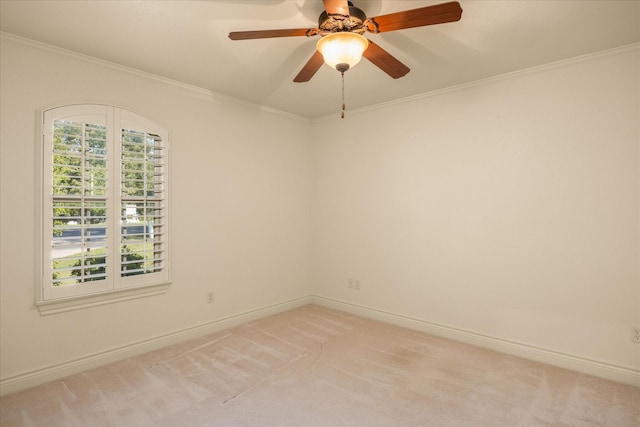 spare room featuring ornamental molding, light carpet, and ceiling fan