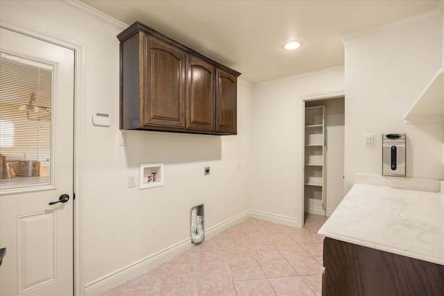 laundry room featuring cabinets, ornamental molding, hookup for an electric dryer, and light tile patterned floors