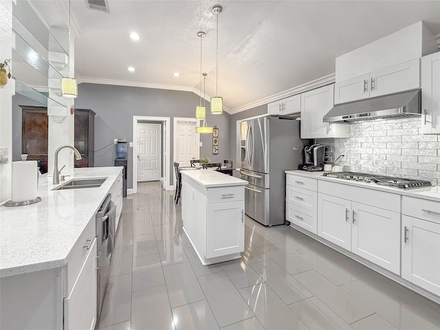 kitchen with an island with sink, appliances with stainless steel finishes, white cabinetry, pendant lighting, and sink