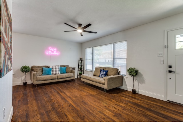 living room featuring ceiling fan and dark hardwood / wood-style flooring