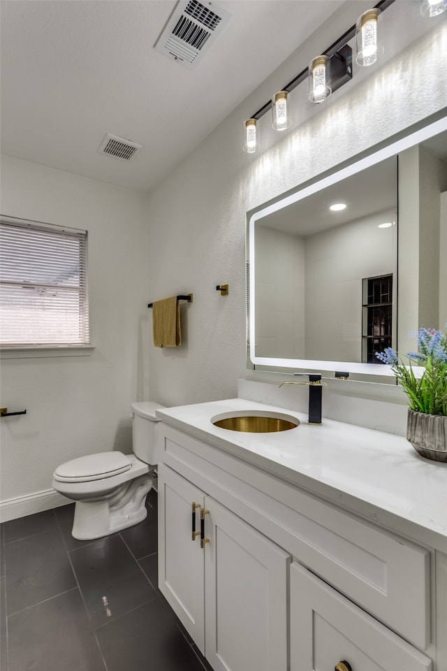 bathroom with tile patterned floors, vanity, and toilet