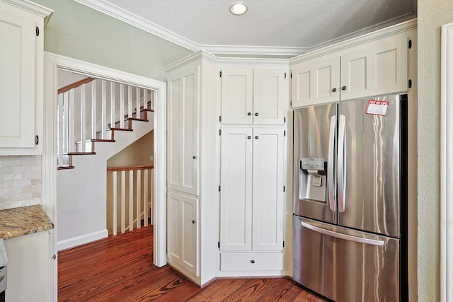 kitchen featuring stainless steel refrigerator with ice dispenser, dark wood-type flooring, and ornamental molding