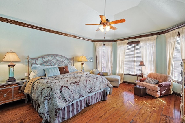 bedroom featuring wood-type flooring, multiple windows, and ceiling fan