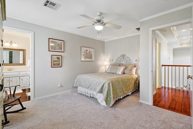 bedroom with ensuite bath, crown molding, ceiling fan, and light colored carpet