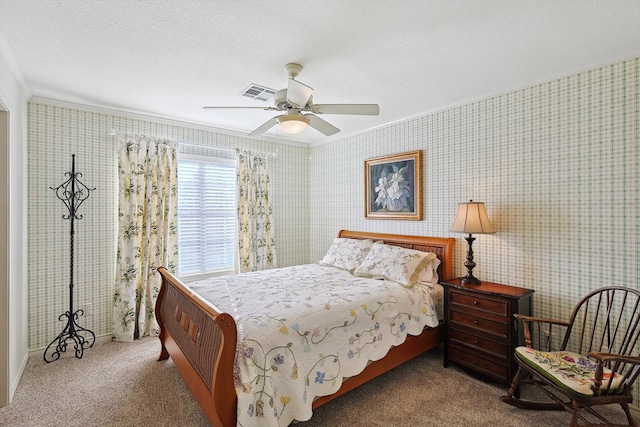 carpeted bedroom featuring ceiling fan, a textured ceiling, and crown molding