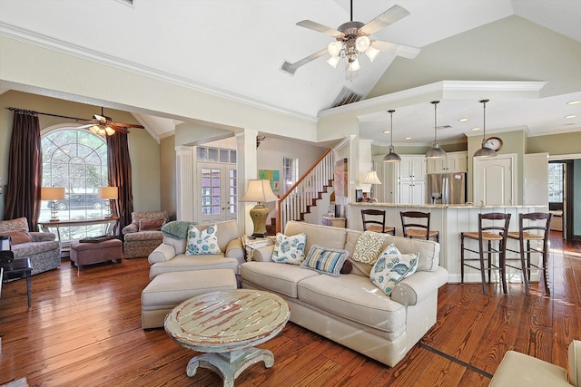 living room featuring lofted ceiling, dark hardwood / wood-style floors, crown molding, and ceiling fan