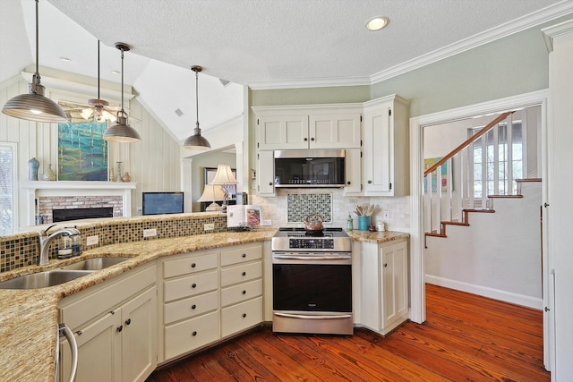 kitchen featuring appliances with stainless steel finishes, sink, dark hardwood / wood-style flooring, and a textured ceiling