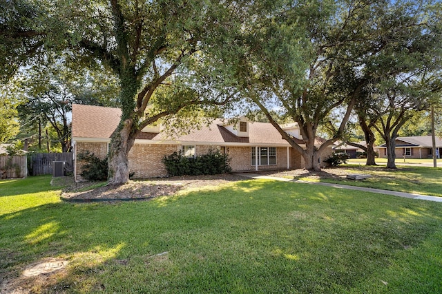 ranch-style house with a front lawn and central AC unit