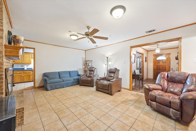 tiled living room with ornamental molding and ceiling fan