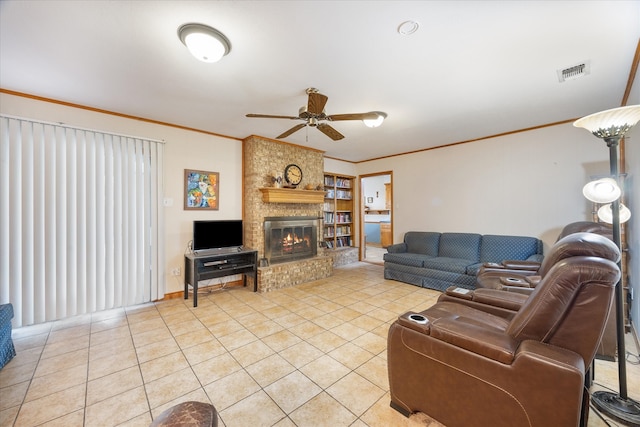 living room with ornamental molding, light tile patterned flooring, a fireplace, and ceiling fan