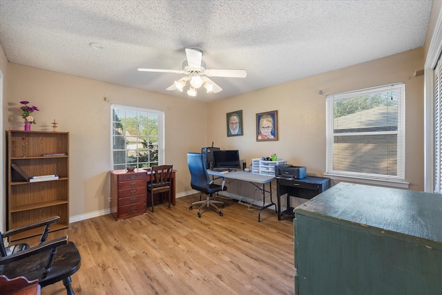 home office featuring ceiling fan, a textured ceiling, and light wood-type flooring