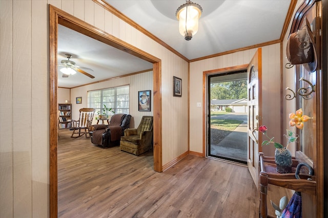 foyer entrance featuring crown molding, hardwood / wood-style flooring, and plenty of natural light