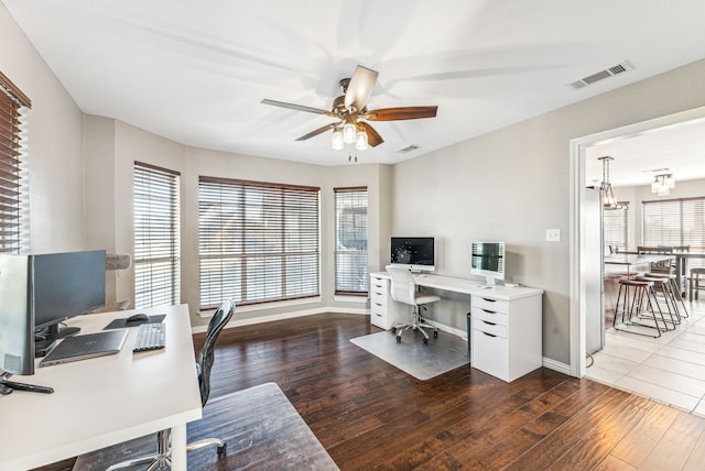 office featuring ceiling fan, a wealth of natural light, and hardwood / wood-style floors