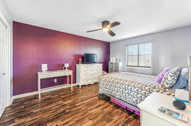 bedroom featuring ceiling fan, a closet, and dark wood-type flooring