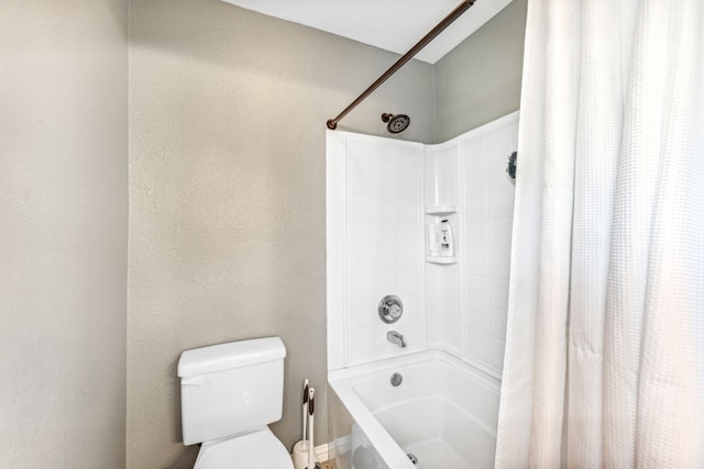 bathroom featuring shower / bath combo and toilet