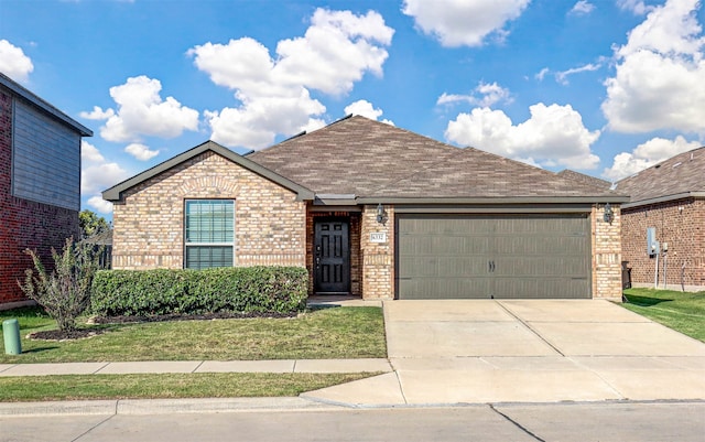 view of front of home with a front yard and a garage