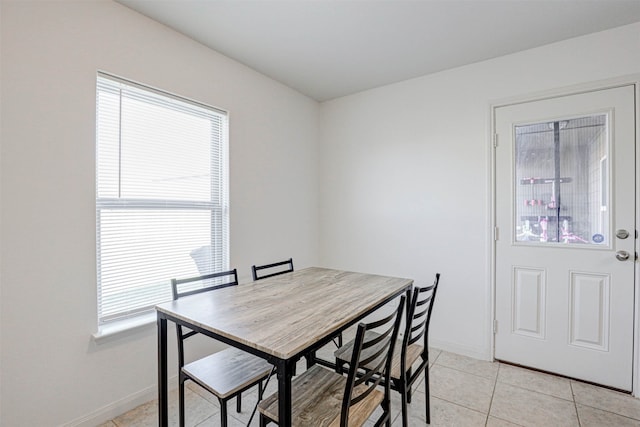 dining space featuring light tile patterned floors