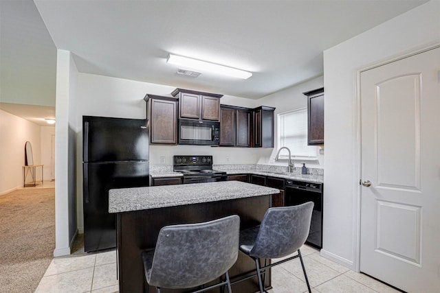 kitchen with sink, a kitchen island, dark brown cabinets, black appliances, and light colored carpet