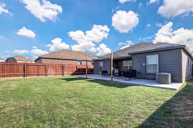 rear view of property featuring a yard, a patio, and central AC unit