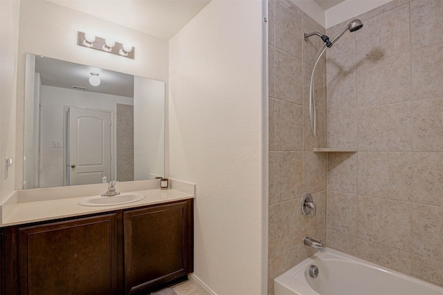 bathroom featuring vanity and tiled shower / bath