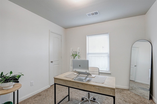 carpeted office featuring a textured ceiling