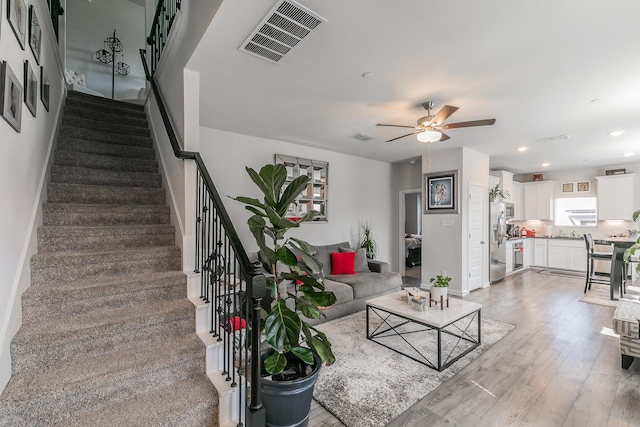 living room featuring hardwood / wood-style flooring and ceiling fan