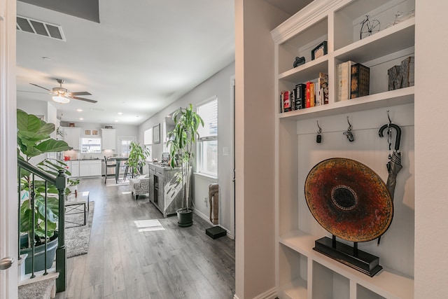 mudroom with ceiling fan and hardwood / wood-style flooring