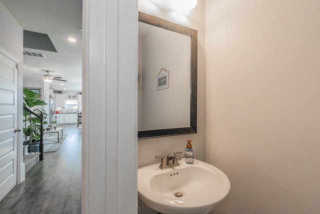 bathroom with hardwood / wood-style flooring, ceiling fan, and sink