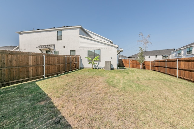 back of house with a lawn