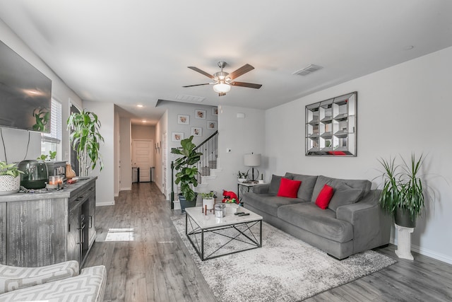 living room featuring hardwood / wood-style floors and ceiling fan