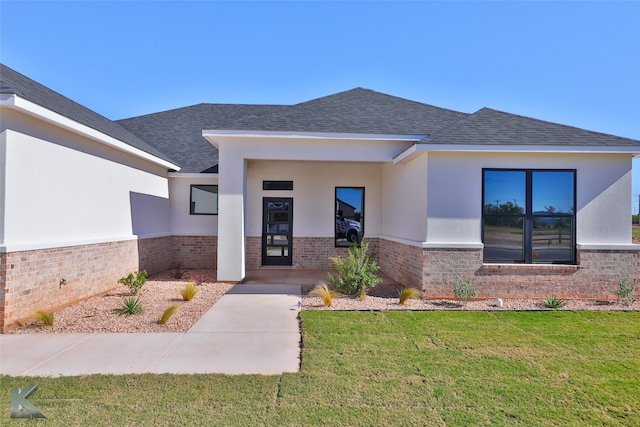 view of exterior entry featuring a yard