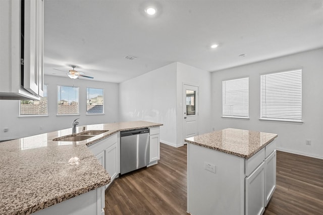 kitchen with dark wood-type flooring, sink, an island with sink, white cabinets, and stainless steel dishwasher