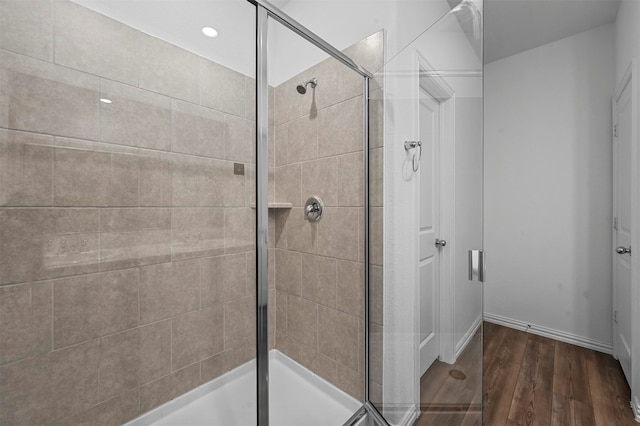 bathroom with wood-type flooring and walk in shower