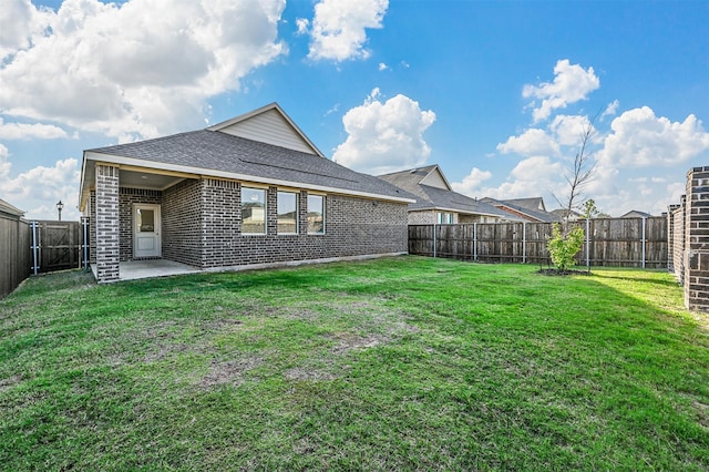 rear view of house featuring a patio and a lawn