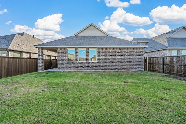 rear view of house featuring a lawn and a patio area