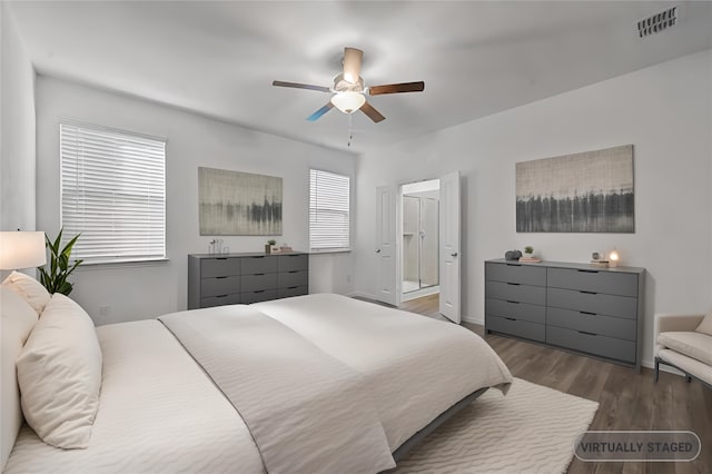 bedroom featuring dark hardwood / wood-style floors, connected bathroom, and ceiling fan