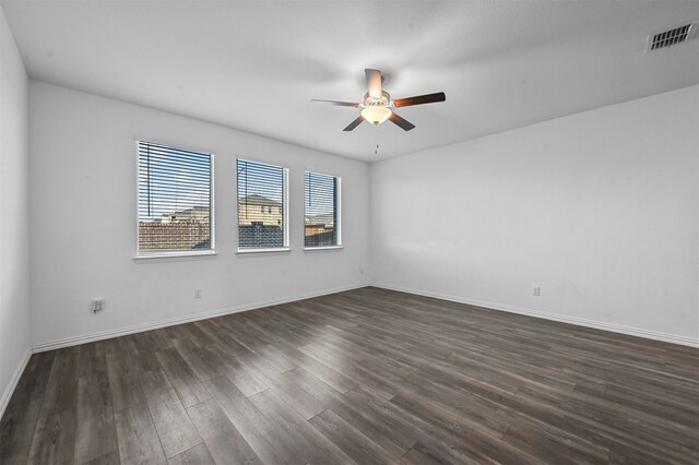 empty room featuring ceiling fan and dark hardwood / wood-style floors