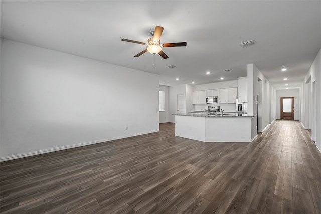 interior space featuring ceiling fan, sink, dark hardwood / wood-style flooring, white cabinetry, and appliances with stainless steel finishes