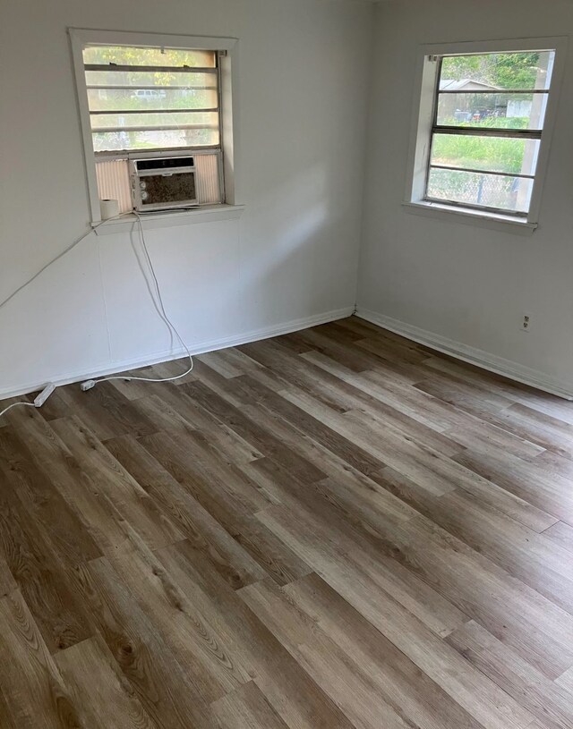 empty room with cooling unit and light wood-type flooring