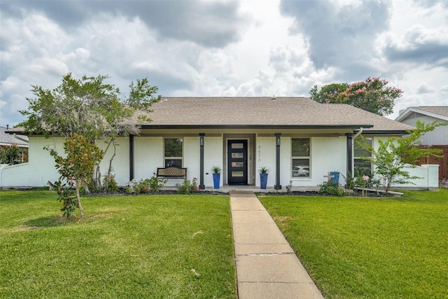 ranch-style house with a porch and a front yard