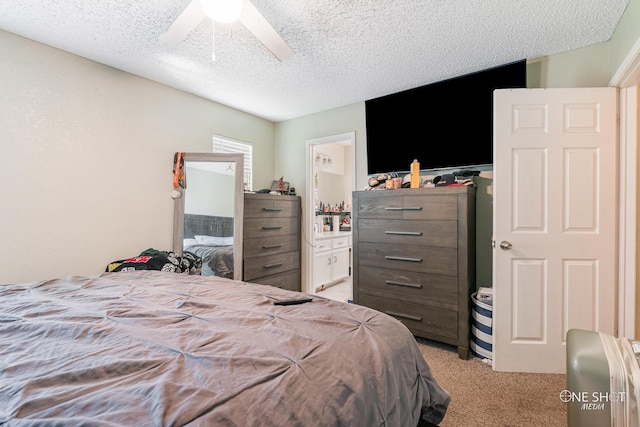 carpeted bedroom featuring a textured ceiling, ceiling fan, and ensuite bathroom