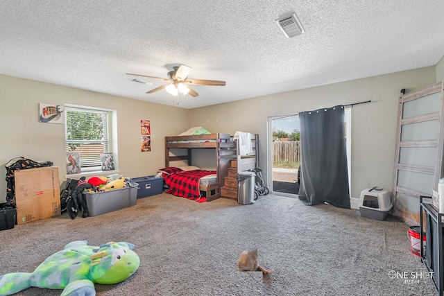 bedroom with access to outside, ceiling fan, carpet flooring, and a textured ceiling